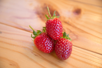 Fresh strawberry in the farm on woodden background