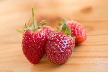 Fresh strawberry in the farm on woodden background