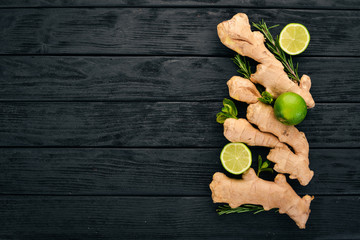 Fresh ginger, lemon and lime on a wooden background. Top view. Copy space.