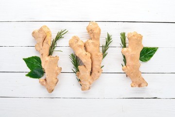 Fresh ginger on a wooden background. Top view. Copy space.