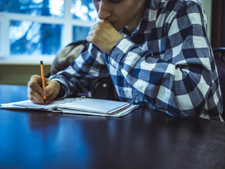 scientist at the table writing in notebook discover new technology checkered shirt