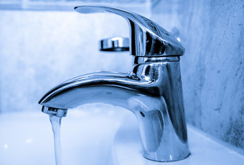 Steel bathroom faucet tap shot closeup 
