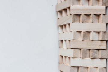 Construction of small wooden blocks for Jenga table game, white background– stock image