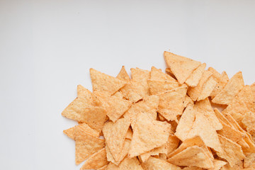 pile of delicious crispy nachos on white background, traditional Mexican cuisine