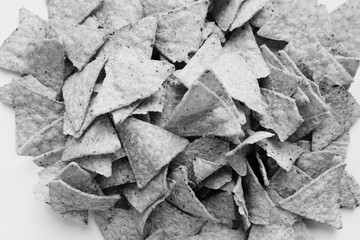 Pile of delicious crispy nachos on white background, traditional Mexican cuisine. Black and white