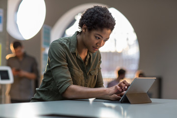 Young adult female working on digital tablet