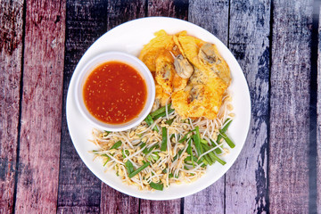Thai food,Fried egg and oyster with bean sprouts and shallot as Hoi Tod Khai in Thai served
