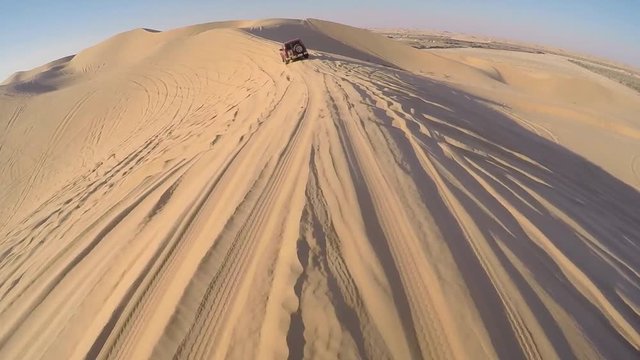 Driving with a four wheel drive through the desert of the United Arab Emirates near Abu Dhabi