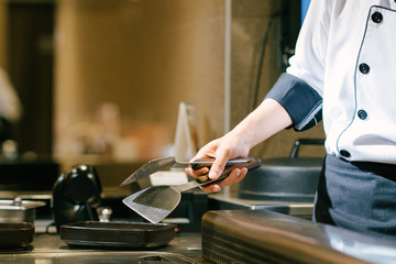 Hand of man take cooking of meat with vegetable grill, Chef cooking wagyu beef in Japanese teppanyaki restaurant