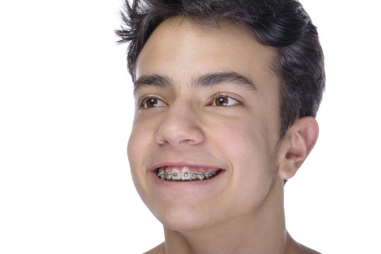 Teen boy wearing braces on white background