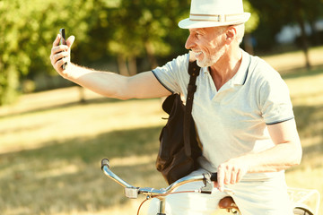 My photo. Handsome cheerful nice man smiling and looking into the camera while taking a selfie