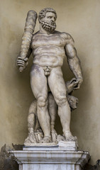 Fototapeta na wymiar Statue of Hercules with a three headed dog at entrance of the Ducal Palace in Modena.