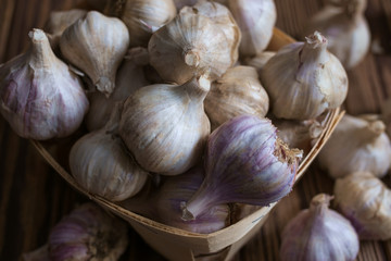 Bulbs of garlic on wooden background