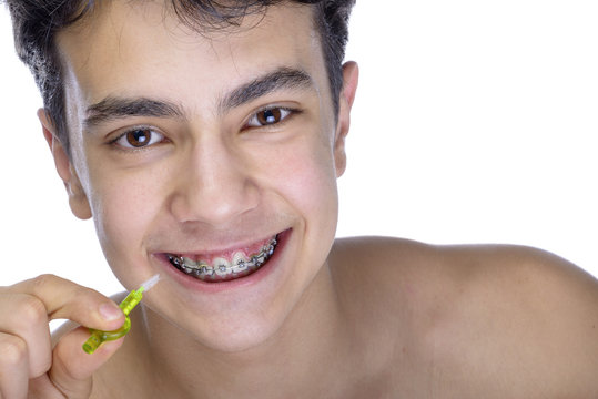 Teen boy wearing braces on white background