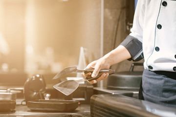 Hand of man take cooking of meat with vegetable grill, Chef cooking wagyu beef in Japanese teppanyaki restaurant