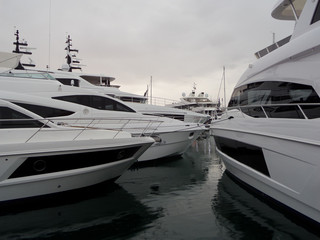 Fototapeta premium Many beautiful white stylish yachts moored in a harbour of Dubai.