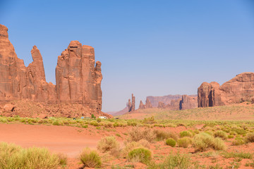 Scenic Drive on Dirt Road through Monument Valley, The famous Buttes of Navajo tribal Park, Utah - Arizona, USA. Scenic road and red rock formations.