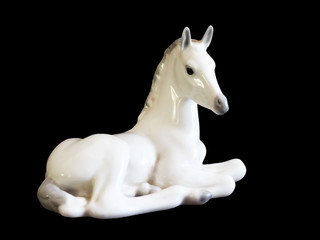 Fototapeta na wymiar Toy horse made of ceramic isolated on black background