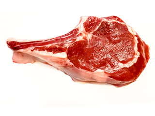 Rib eye on the bone or cowboy steak of beef or veal on a white background with shadow