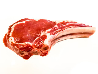 Rib eye on the bone or cowboy steak of beef or veal on a white background with shadow