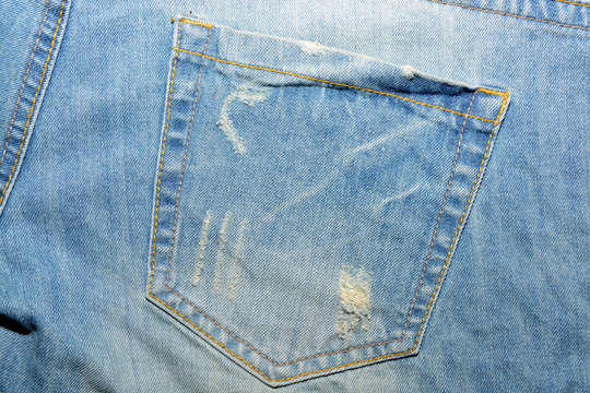 The texture is denim with a pocket