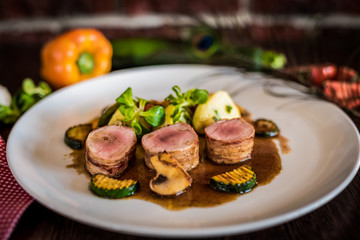 Steak chicken breast olive oil cherry tomatoes pepper and rosemary herbs.