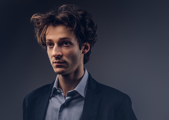 Studio portrait of a stylish sensual male with hairstyle in a casual suit