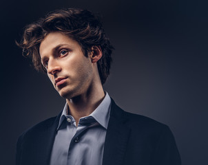 Studio portrait of a stylish sensual male with hairstyle in a casual suit