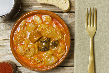 Spanish callos and ingredients on a white blackground