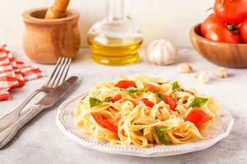 Pasta with tomato sauce served with basil