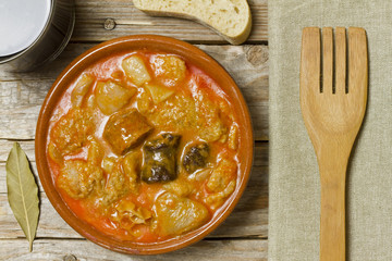 Spanish callos and ingredients on a white blackground