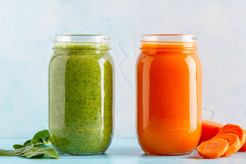 Orange/green colored smoothies / juice in a jar