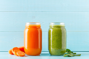 Orange/green colored smoothies / juice in a jar