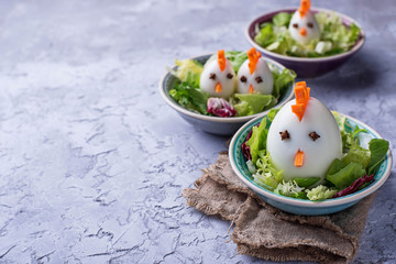 Salad with eggs in shape of chickens. Festive food.
