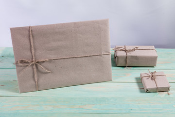 Presents for any holiday concept. Border of decorative gifts wrapped kraft paper tied with tourniquet for christmas, valentine day or birthday