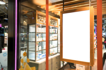 empty wood frame poster display on glass window at shop storefront,sale and discount promotion information for announcement successful business marketing,selective focus