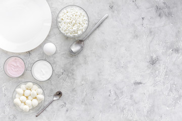 Fresh dairy products. Milk, cottage, cheese, yougurt on grey table top view mock up