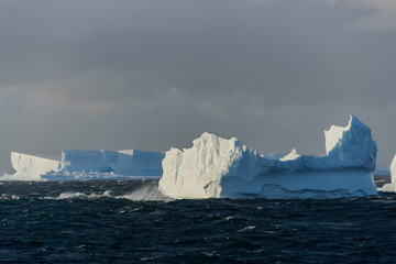 Iceberg in wavy sea