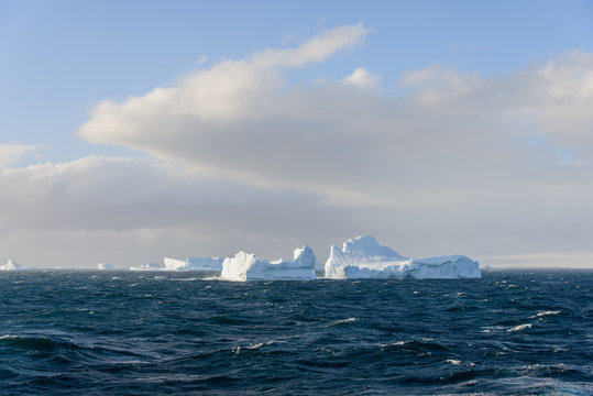 Iceberg in wavy sea