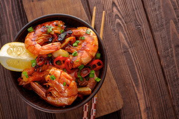 Large grilled BBQ shrimp with sweet chili sauce, green onion and lemon, copyspace