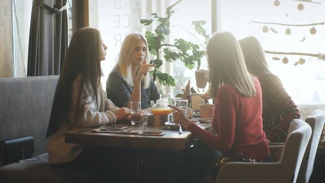 company friends talking in a cafe and having fun