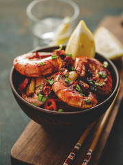 Large grilled BBQ shrimp with sweet chili sauce, green onion and lemon. Toned image