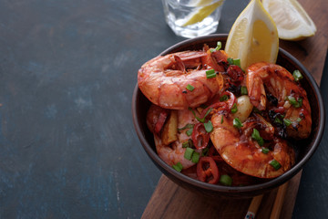 Large grilled BBQ shrimp with sweet chili sauce, green onion and lemon, copyspace