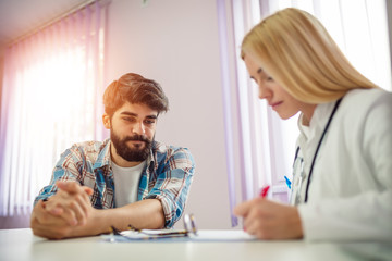 Female doctor meeting with a patient in the office. Healthcare and medicine concept. Doctor talking patient .