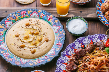 Homemade hummus with pita in traditional plate