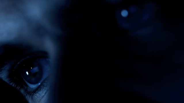 eyes of hackers attacking the system on the computer in the dark