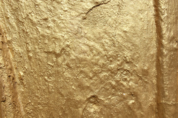 Texture and background wall in gold color with surface irregularities