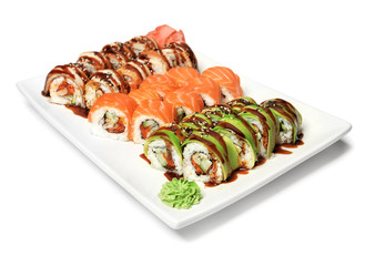 Plate with set of delicious sushi rolls on white background