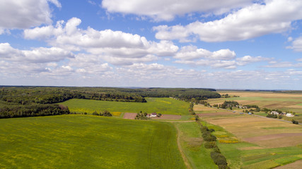 Naklejka premium the green field is at sunset shot with the drone