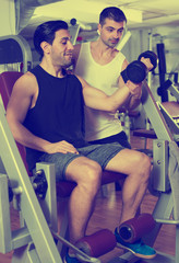 Guy with trainer in gym